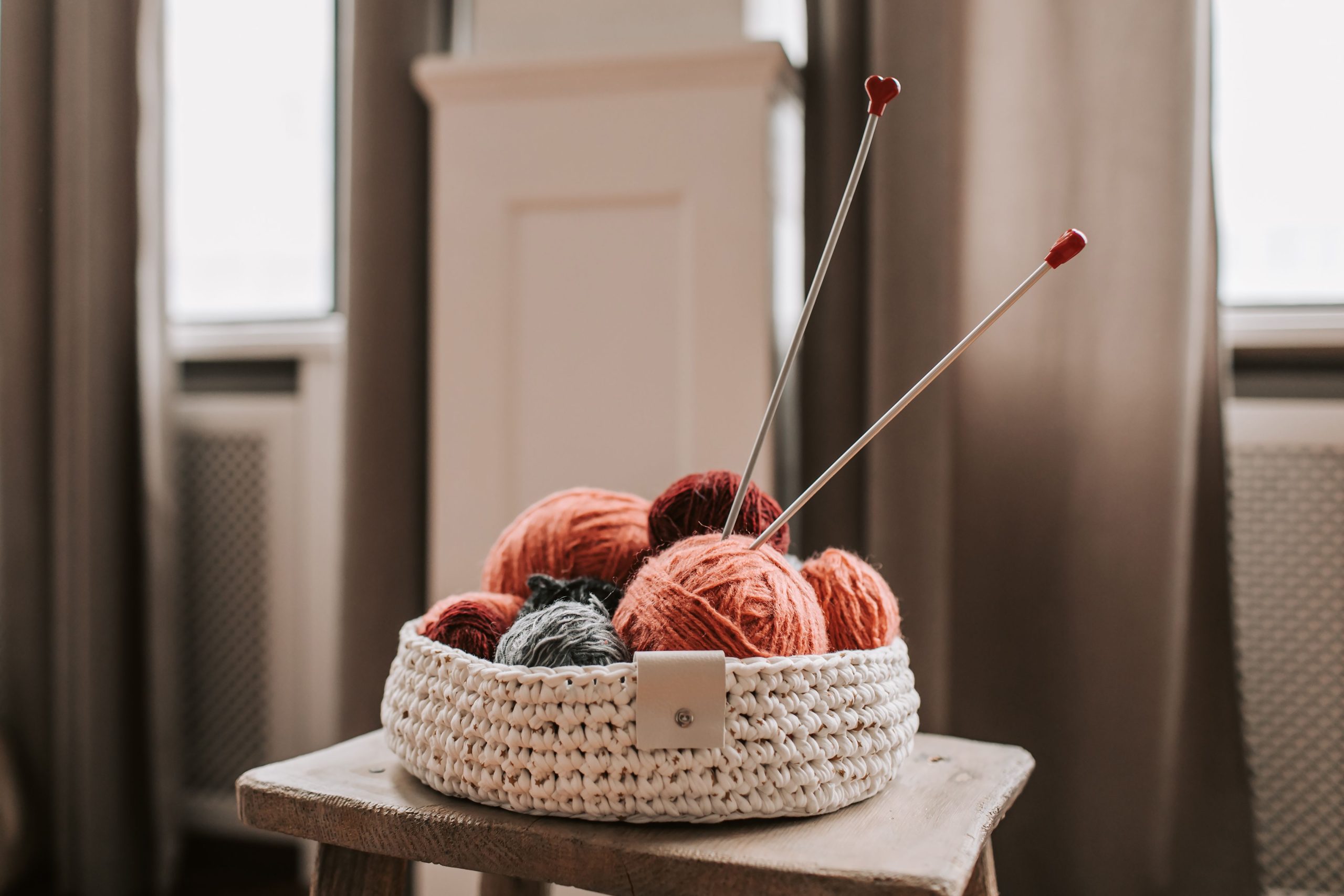 Panier de laine et aiguilles tricot sur chaise