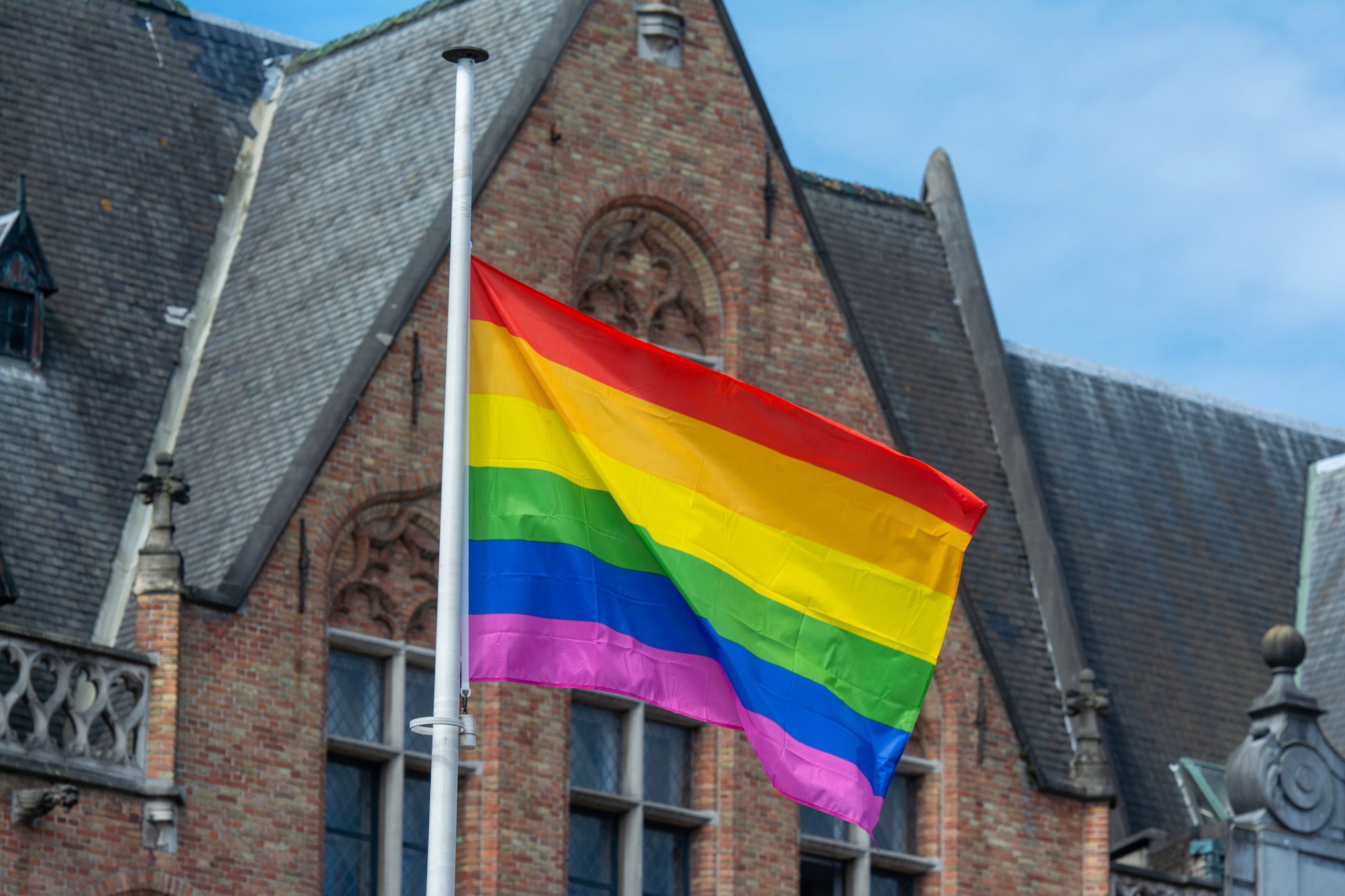 Drapeau arc en ciel devant un bâtiment historique